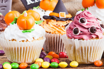 Halloween cupcakes with colored decorations
