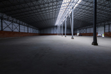 A huge metal construction warehouse. Grain dryer and threshing floor. Blurred-unrecognizable faces of people. Concept theme is the production of food and agricultural production.