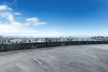 empty concrete road with cityscape of modern city in blue sky