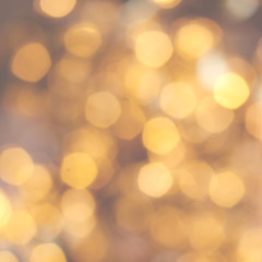 Golden Christmas background with natural  bokeh and twinkled defocused lights. Festive blur background .