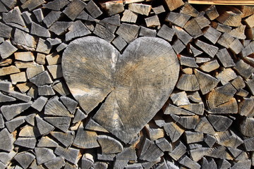 Holzherz 
Ein Herz aus Holz wurde in einem Stapel gespaltenem Holz eingebettet