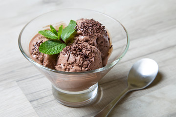 Homemade chocolate ice cream with chocolate crumbs. 3 balls. Close-up. Selective focus.