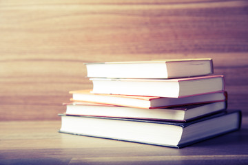 Books on wooden deck table background