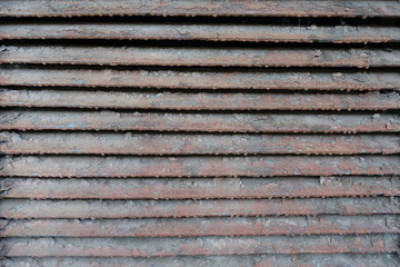 Old rusty dirty peeled horizontal metallic slats