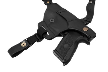 pistol in a black leather holster isolated on white