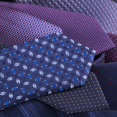 Beautiful silk ties are stacked together.