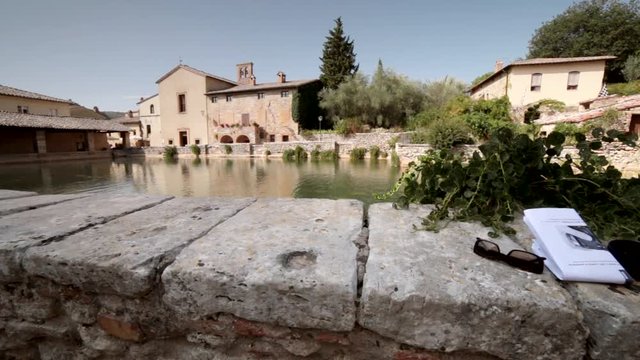 huge pool of thermal water  in the picturesque square in Tuscan village near Siena