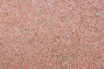 Seamless texture of a coating of crumbs of red decorative stones