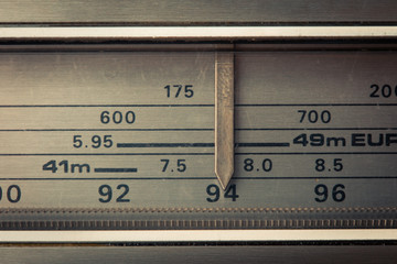 Vintage radio tuning dial, strong differential focus. Styled photo
