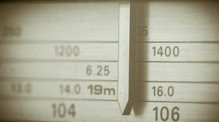 Vintage radio tuning dial, strong differential focus. Styled photo