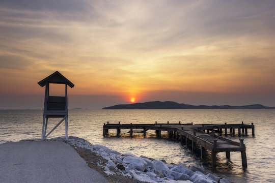 sunrise seascape with tower observation old small Located at the end of the road Behind Older port and sea in the khao laem ya ,mu ko samet national park ,thailand.