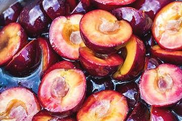 plums chopped on jam texture background