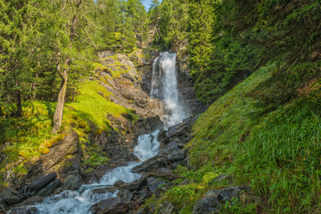 Fototapeta na wymiar waterfall mountain landscape. Rabbi Valley, Trentino Alto Adige, Italy