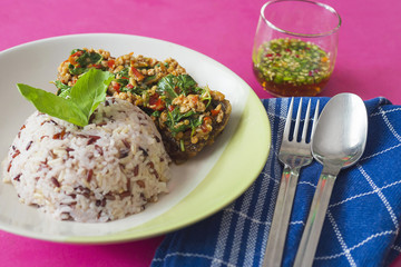 Thai style fried chilly basil with minced pork and preserved egg and mixed rice meal ready for serving