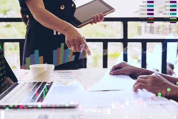 Working women are discussing in their office with stock chart and data overlay