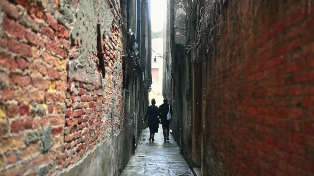 Couple walking along narrow street