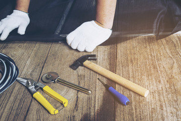 Man is working with mosquito wire screen installation