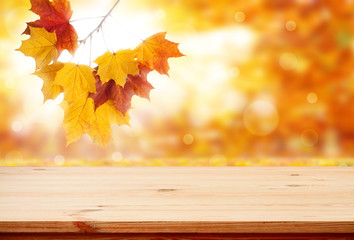Naklejka na ściany i meble Wood table top on shiny bokeh autumn background - can be used for display or montage your products