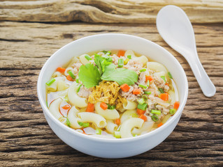 Macaroni soup putting on wooden background