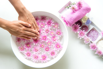 Obraz na płótnie Canvas Spa treatment and product for female feet and manicure nails spa with pink flower, copy space, soft and select focus, Thailand. Healthy Concept.