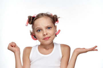 little girl in curlers on white background, portrait