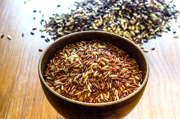 brown rice in wooden bowl