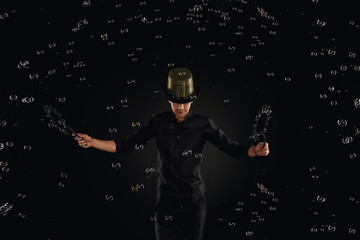 Man artist fiddle with many soap bubble. Soap bubble show in black studio.