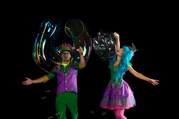 Artist team make amusement soap bubble. Soap bubble show in black studio.