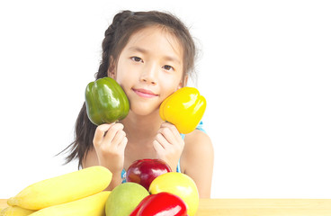 Fototapeta na wymiar Asian healthy gril showing happy expression with variety colorful fruit and vegetable over white background