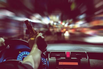 Papier Peint photo Voitures rapides Man drink beer while driving at night in the city dangerously, left hand drive system