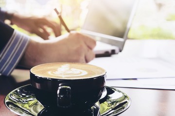 Businessman is working with his computer in coffee shop