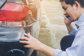 Man is calling insurrance company for claiming his car crash damaged on road accident