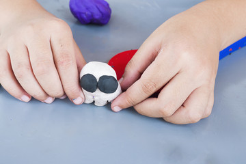 Boy is happily playing clay toy