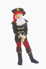 Asian boy smiling in pirate costume isolated over white