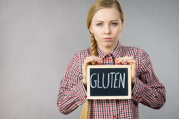 Woman holding board with gluten sign