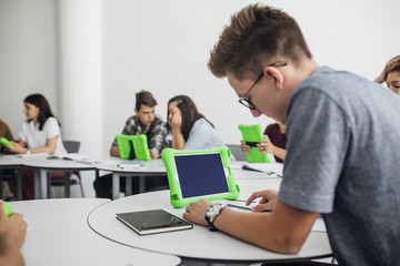 High School Students Using Tablets in Round Classroom