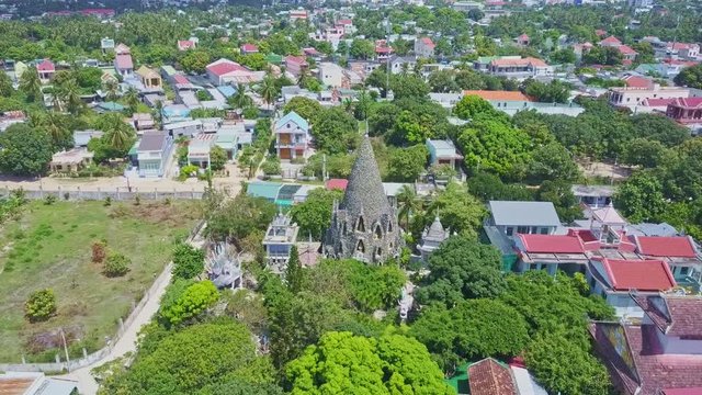 Drone Moves to Buddhist Temple Cone Tower against City