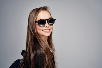 beautiful girl in sunglasses smiling, child, blank space for copy