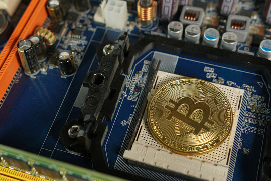 Bitcoins on the motherboard. Crypto currency Gold Bitcoin - BTC - Bit Coin.