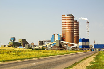Concrete factory. Industrial cement processing facility exterior in sunny summer day. Concrete-mixing plant.
