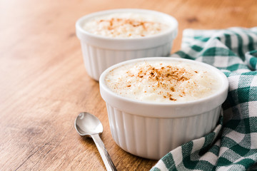 Arroz con leche. Rice pudding with cinnamon on wooden background
