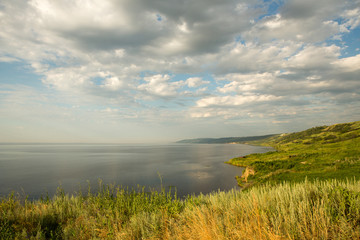 river, landscape, green meadow. the cliff and the sky