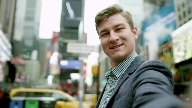 Young man looking in the camera and making funny moves