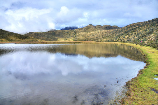 Lake Limpiopungo, in the Cotopaxi National Park, on a foggy and cloudy morning, reflecting the sky. Ecuador.