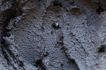 Black volcanic cosmetic clay in a bowl. cosmetic clay texture close up. solution cosmetic clay abstract background