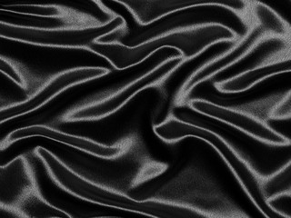 Luxurious elegant black silk or satin waves for abstract background