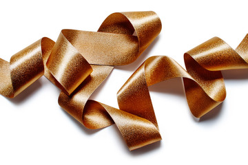 Close up of metallic gold bronze ribbon isolated on white background
