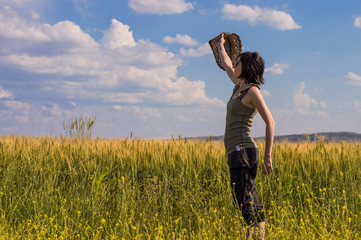 Young woman with hat enjoying the nature. Freedom concept.