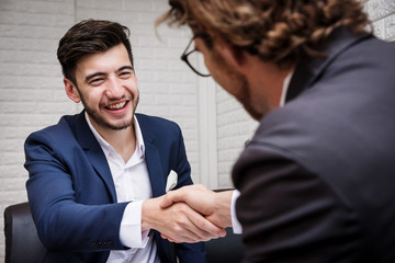 Businessman Shaking Hand with Partner After Sign Contract in Meeting Room with Happy - Business Concept