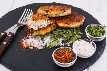 Meat dishes on black stone plate